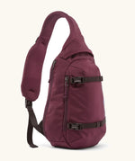 Patagonia atom sling 8L bag in berry fig. Over the shoulder strap with zipped compartments and equipment straps on the front.