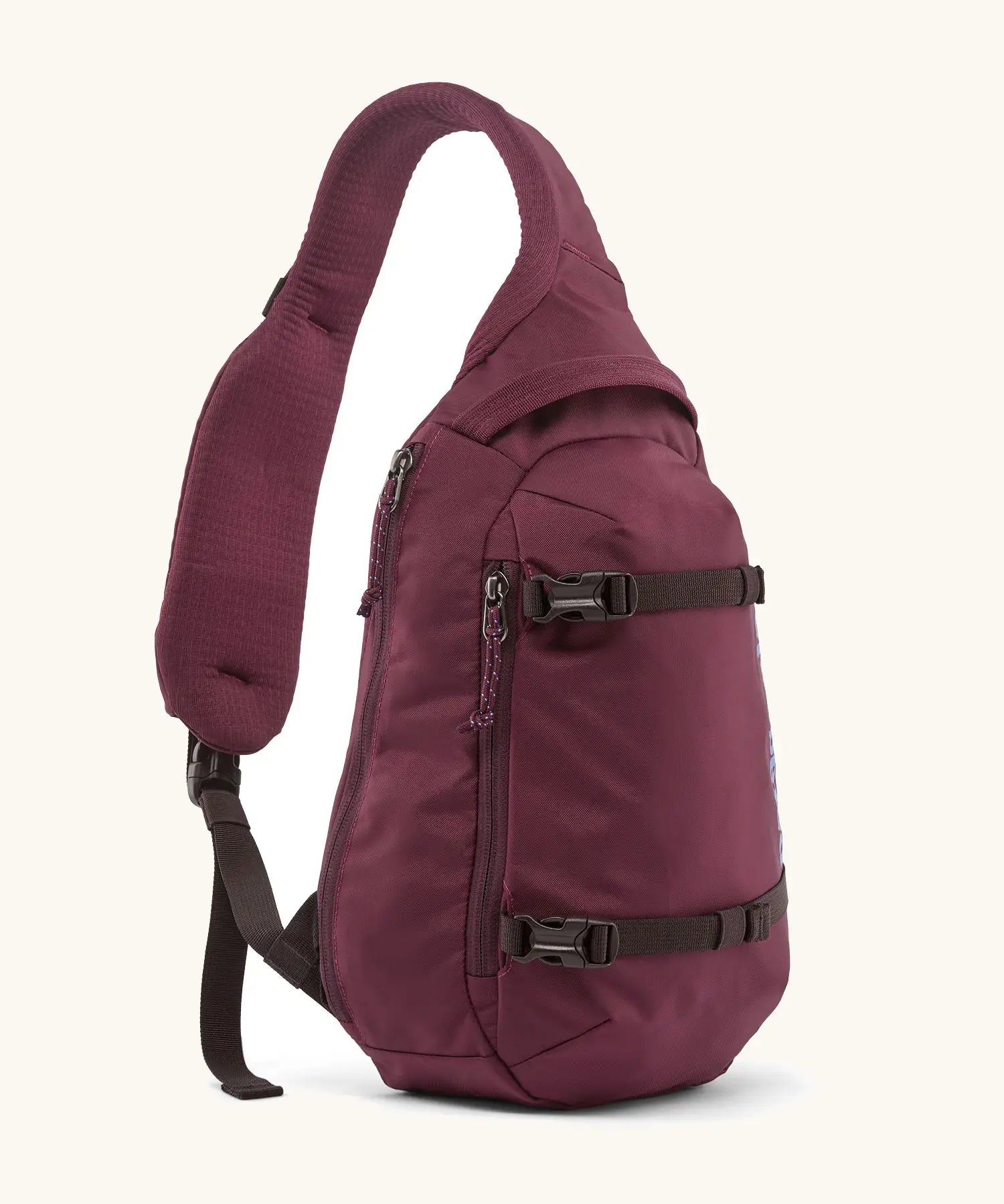 Patagonia atom sling 8L bag in berry fig. Over the shoulder strap with zipped compartments and equipment straps on the front.