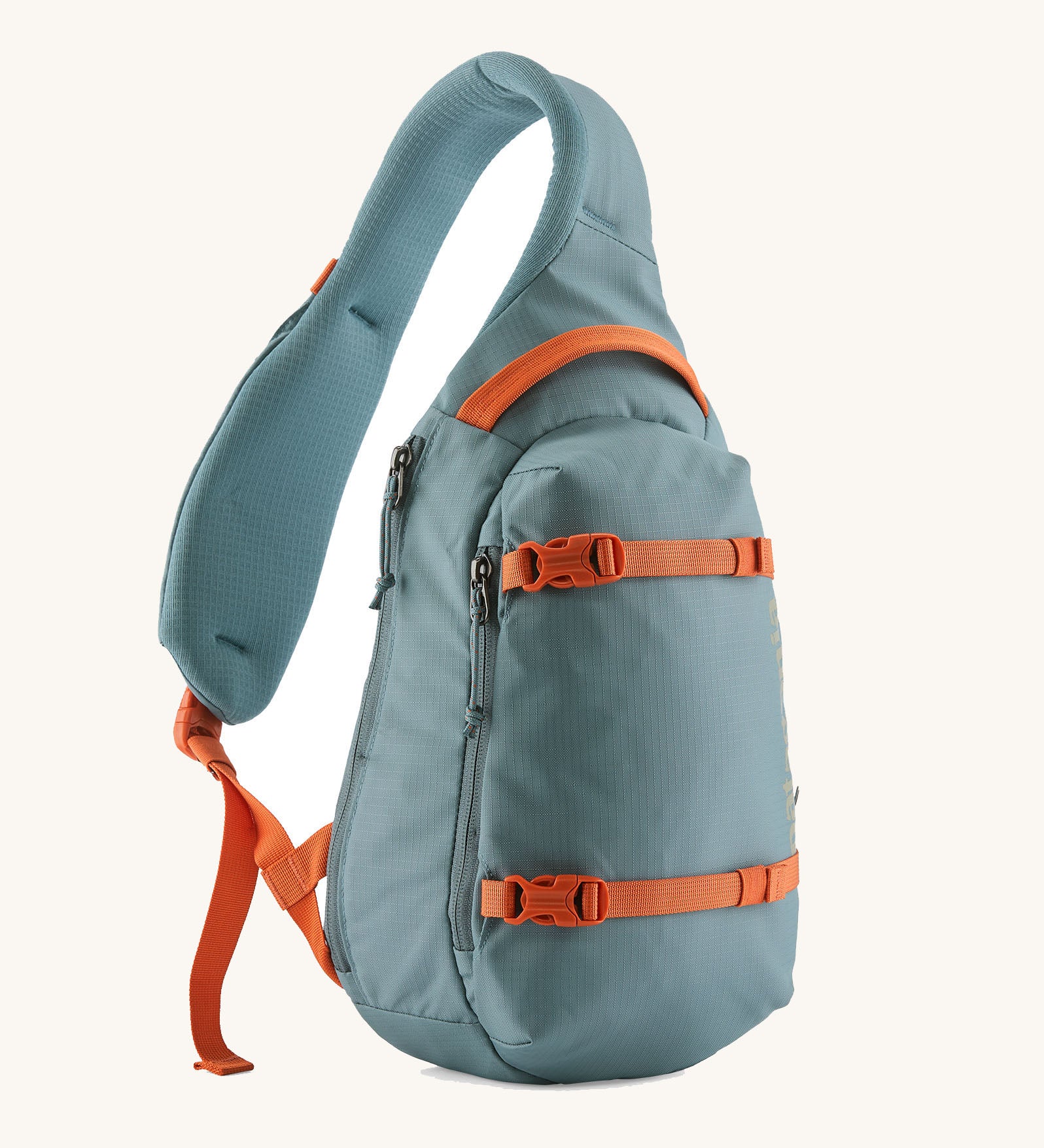 Patagonia atom sling 8L bag in blue sage with orange handle straps, gear loops and quick release buckles. 