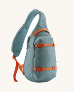 Patagonia atom sling 8L bag in blue sage with orange handle straps, gear loops and quick release buckles. 