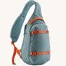 Patagonia atom sling 8L bag in blue sage with orange handle straps, gear loops and quick release buckles. 