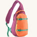 Patagonia atom cross body 8L sling bag in faded magenta with an orange front pocket and handle and mint gear straps and buckles.