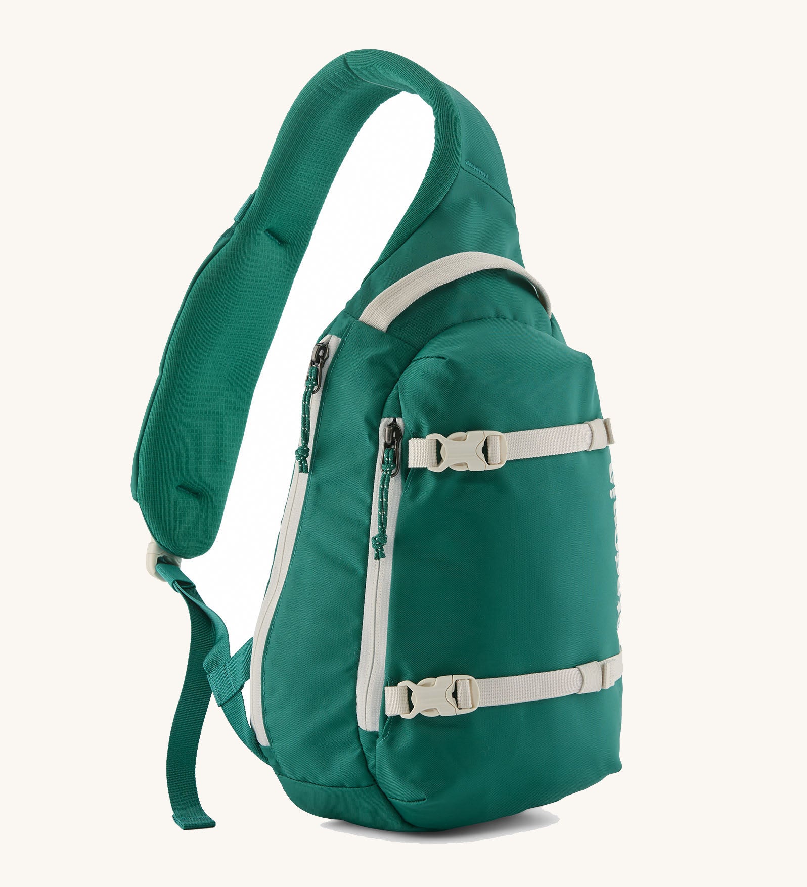 Patagonia atom cross body 8L sling bag in gem green with grey handle, zips, gear straps and buckles.