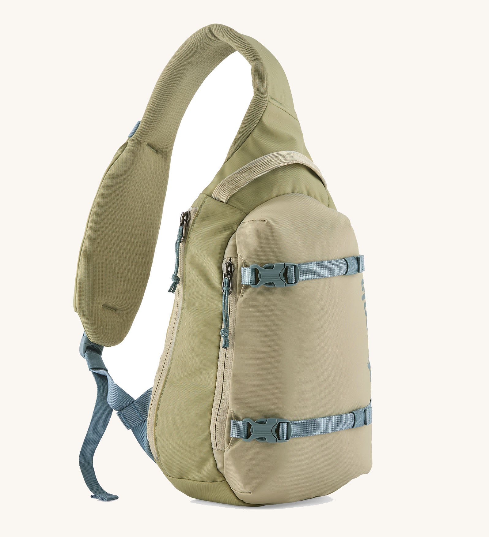 Patagonia atom cross body 8L sling bag in weathered stone with grey gear straps and buckles.