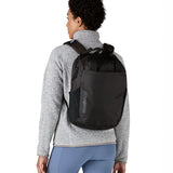 Person wearing the Patagonia atom 20 litre black tote bag backpack on their back.
