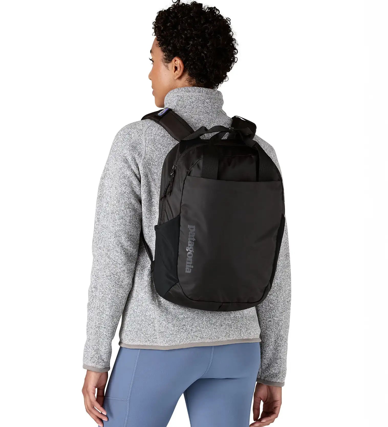 Person wearing the Patagonia atom 20 litre black tote bag backpack on their back.