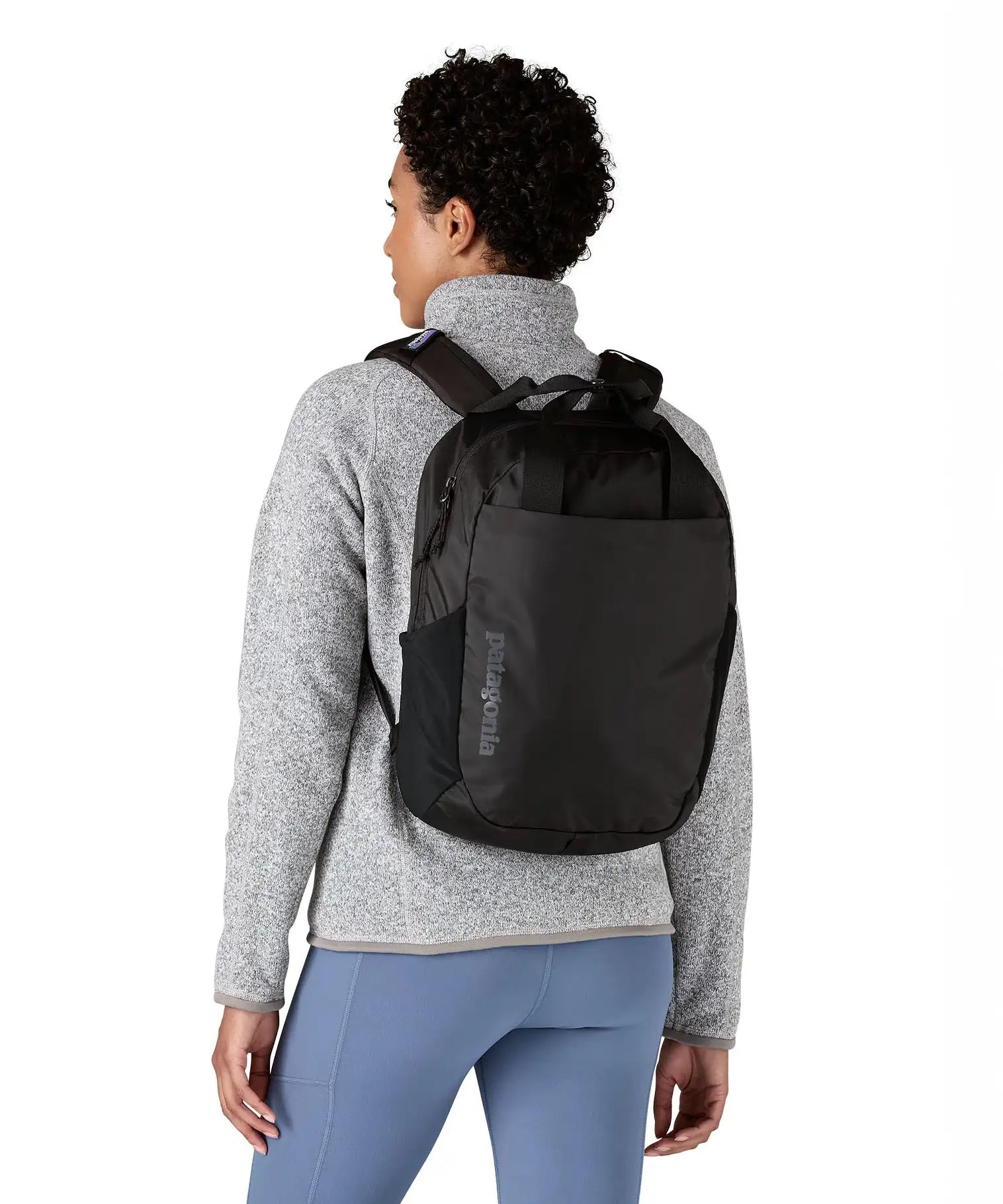 Person wearing the Patagonia atom 20 litre black tote bag backpack on their back.
