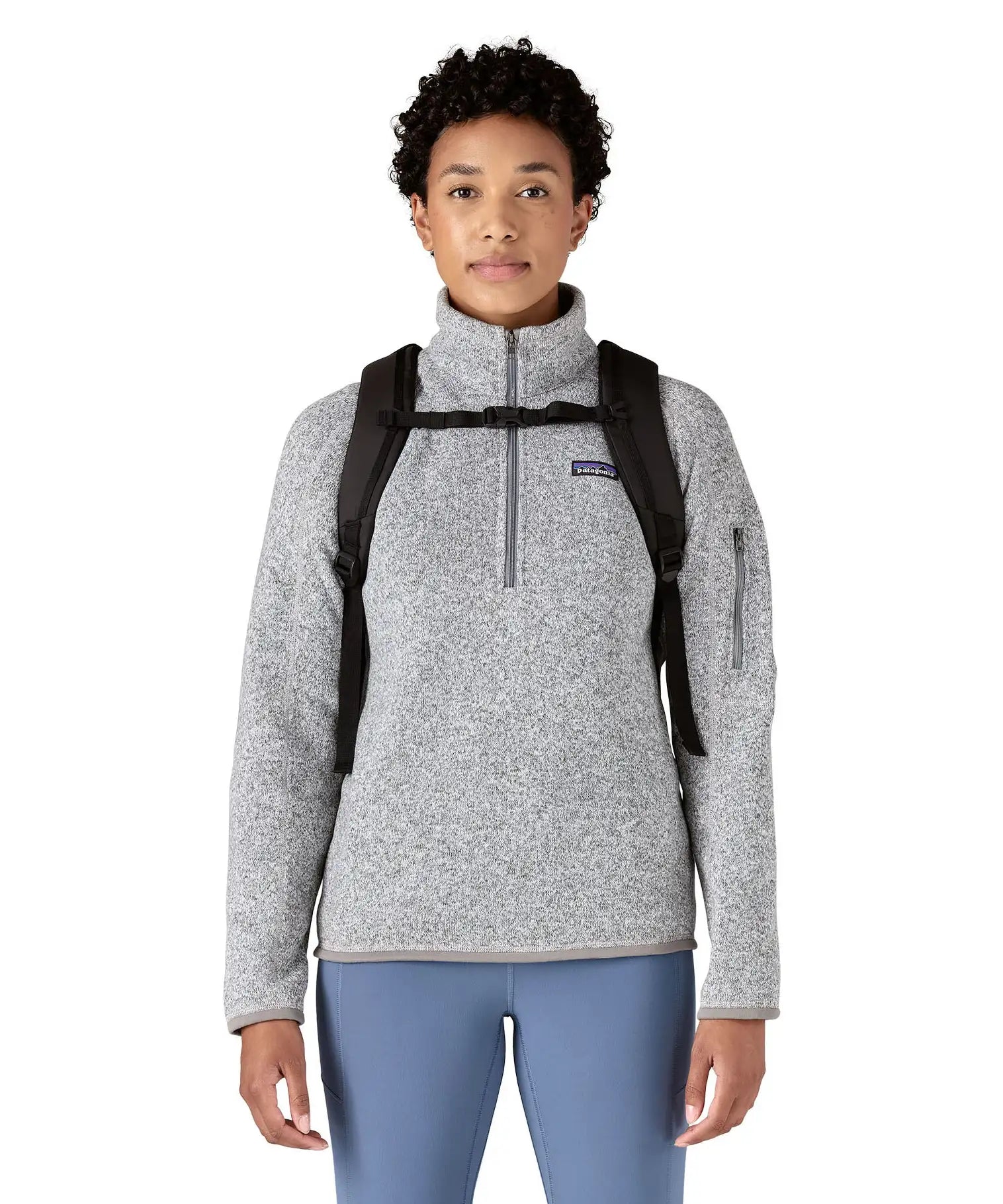 Person wearing the Patagonia atom 20 litre black tote bag backpack with the chest strap closed across their front.