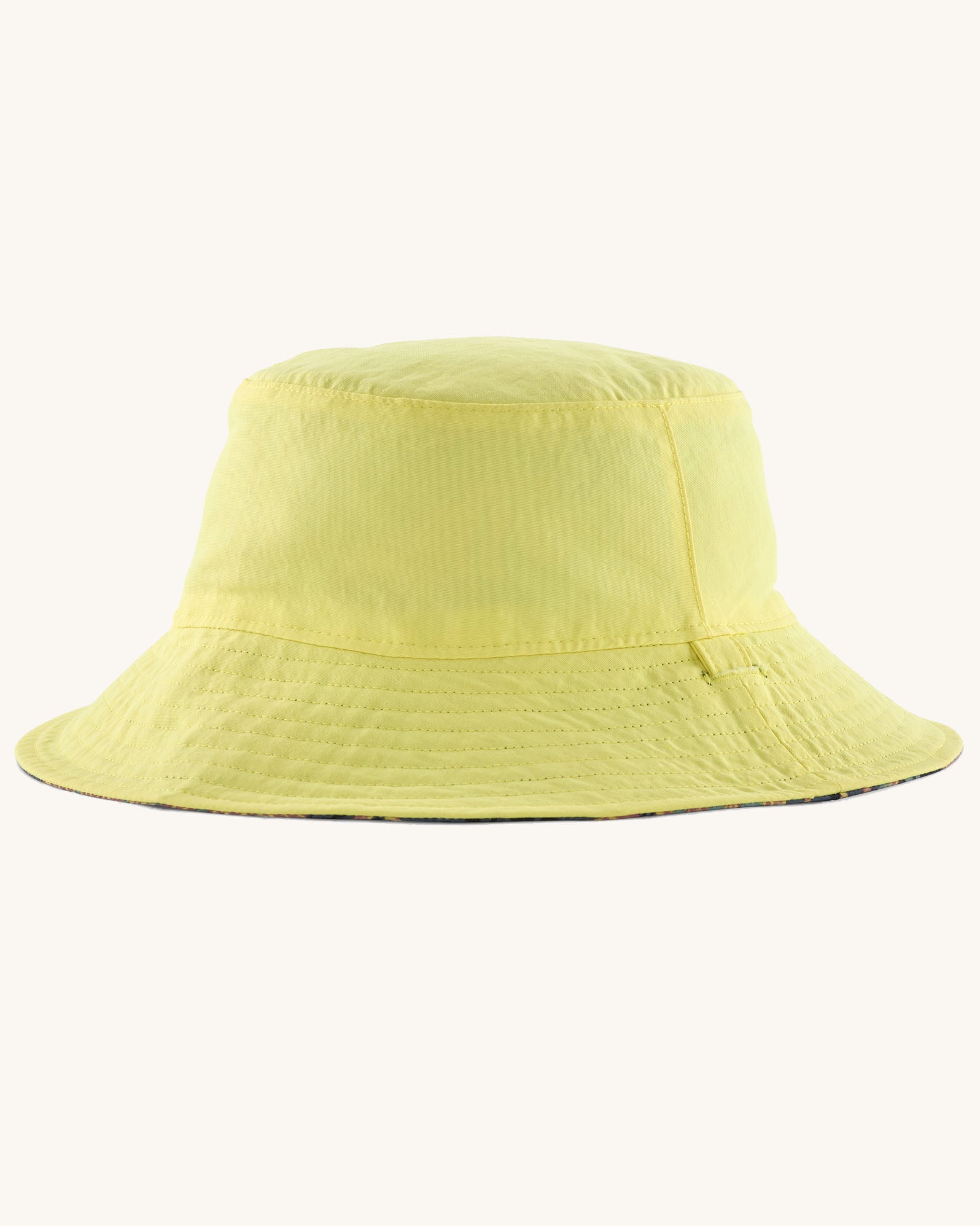 Patagonia reversible baby sun bucket hat shown on the plain light lime green side.