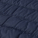 A close up of water droplets shown on the outer material of the Patagonia Little Kids Down Sweater - New Navy. 