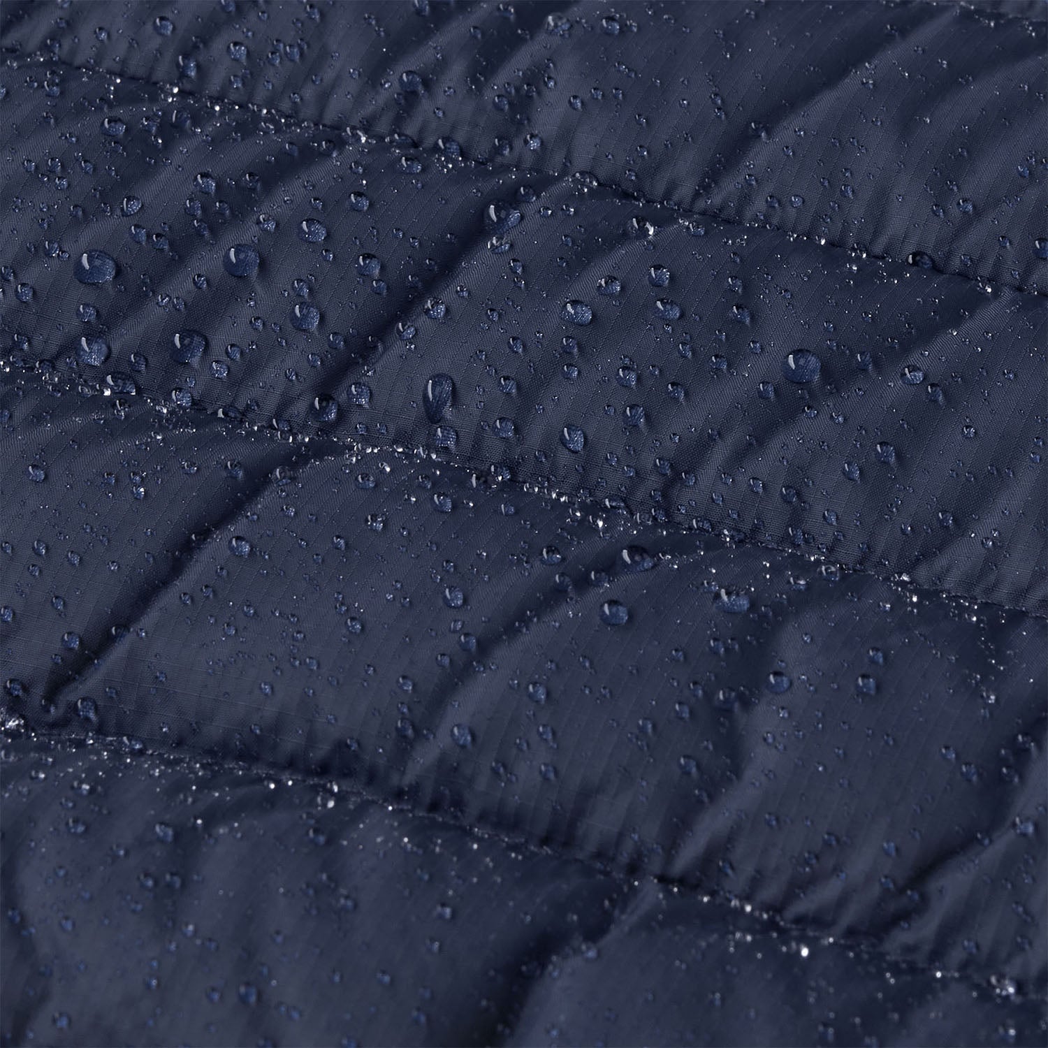 A close up of water droplets shown on the outer material of the Patagonia Little Kids Down Sweater - New Navy. 
