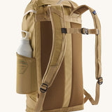 Patagonia lid fieldsmith lid backpack in classic tan showing the Shoulder strap detail with buckle fastening. Features a side mesh pocket for holding water bottles. 