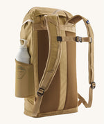 Patagonia lid fieldsmith lid backpack in classic tan showing the Shoulder strap detail with buckle fastening. Features a side mesh pocket for holding water bottles. 