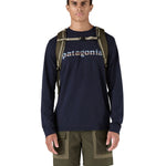 Patagonia 25L black hole backpack in a basin green colour shoulder strap and clip detail