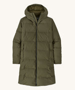 Patagonia women's glacier parka coat in basin green colour on a cream background.