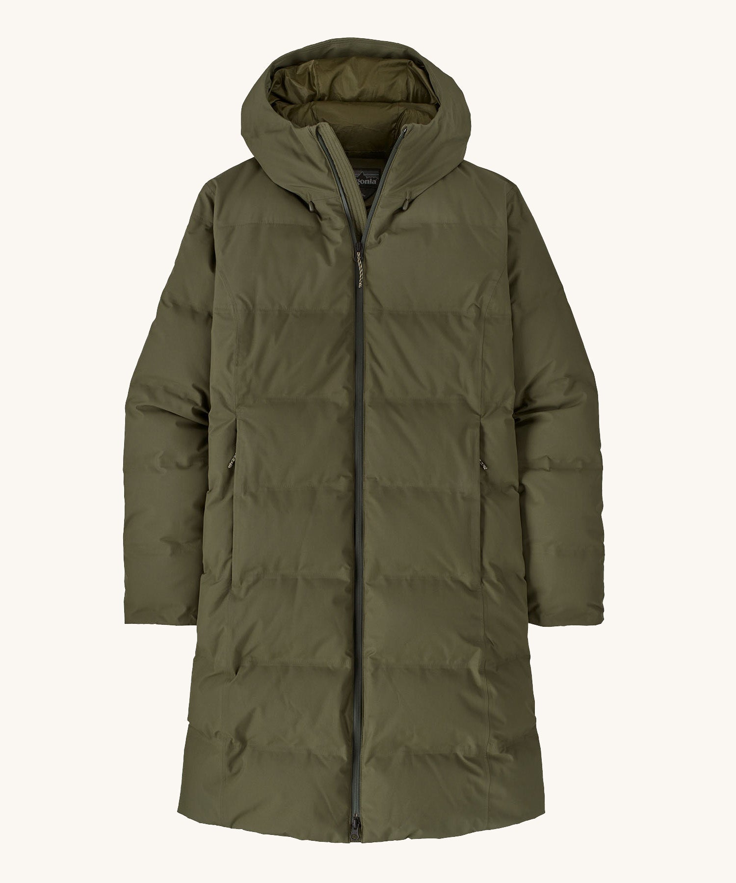 Patagonia women's glacier parka coat in basin green colour on a cream background.