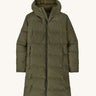 Patagonia women's glacier parka coat in basin green colour on a cream background.