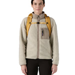 Patagonia 25L black hole backpack in a beeswax tan colour shoulder strap and clip detail