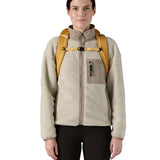 Patagonia 25L black hole backpack in a beeswax tan colour shoulder strap and clip detail