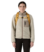 Patagonia 25L black hole backpack in a beeswax tan colour shoulder strap and clip detail