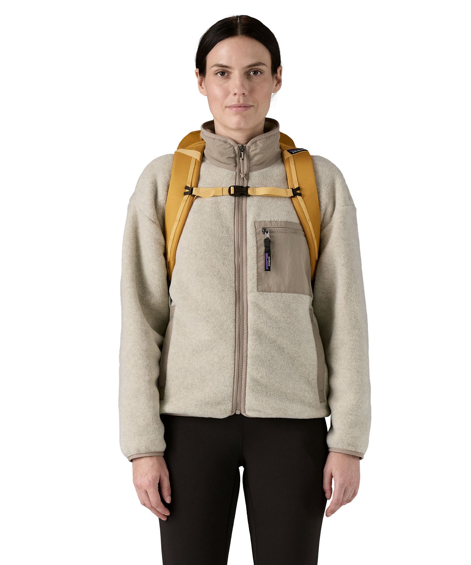 Patagonia 25L black hole backpack in a beeswax tan colour shoulder strap and clip detail