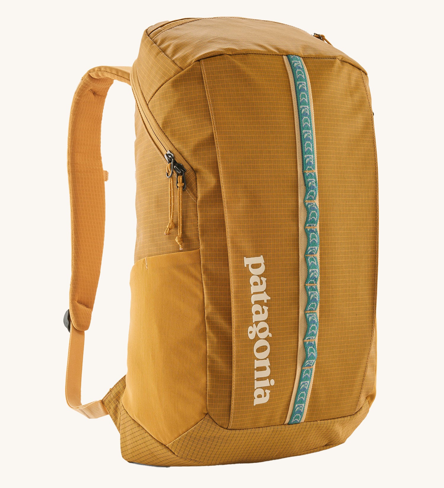 Patagonia 25L black hole backpack in a beeswax tan colour on a cream background.