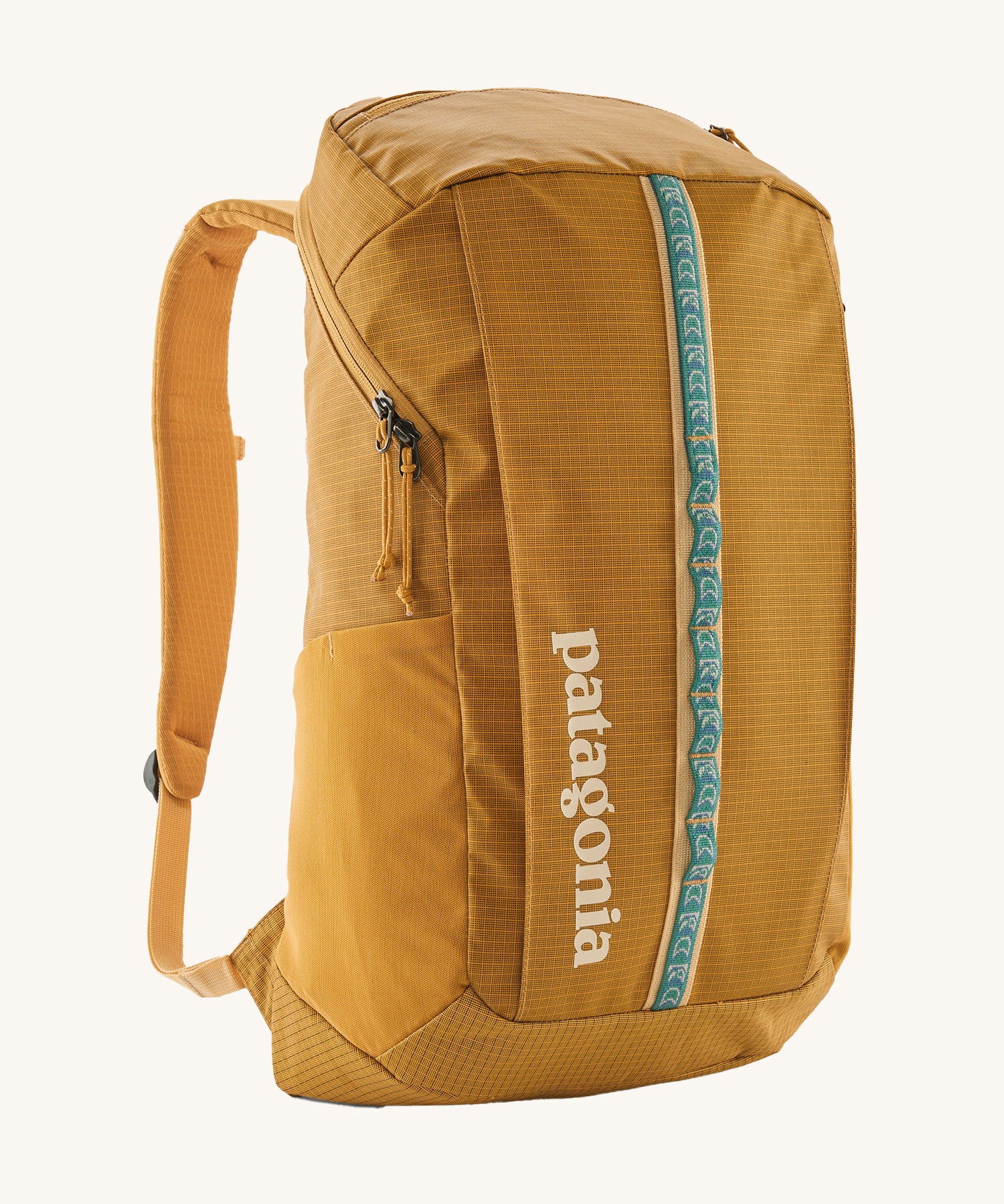 Patagonia 25L black hole backpack in a beeswax tan colour on a cream background.