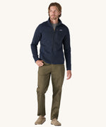 A man wearing the Patagonia Men's Better Sweater Jacket in a New Navy colour.