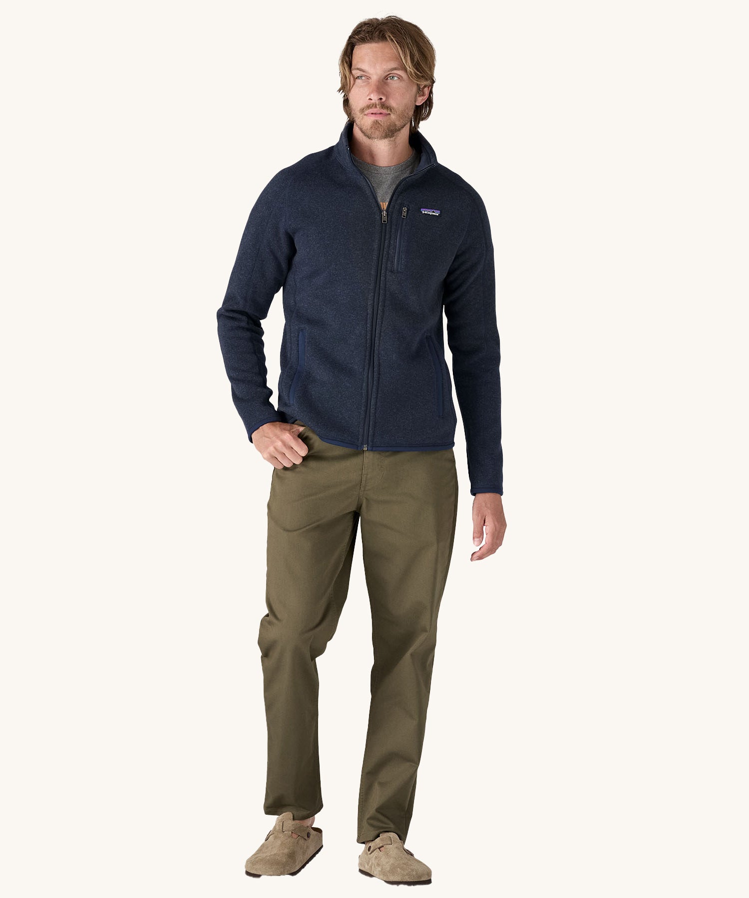 A man wearing the Patagonia Men's Better Sweater Jacket in a New Navy colour.