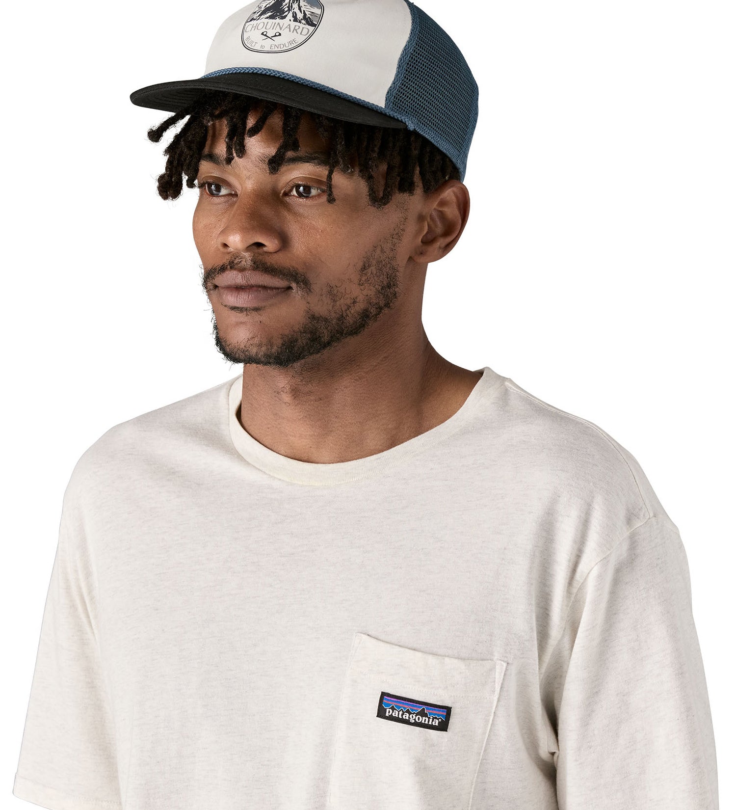 Patagonia airfarer cap in a birch white colour and Chouinard crest design worn by an adult 