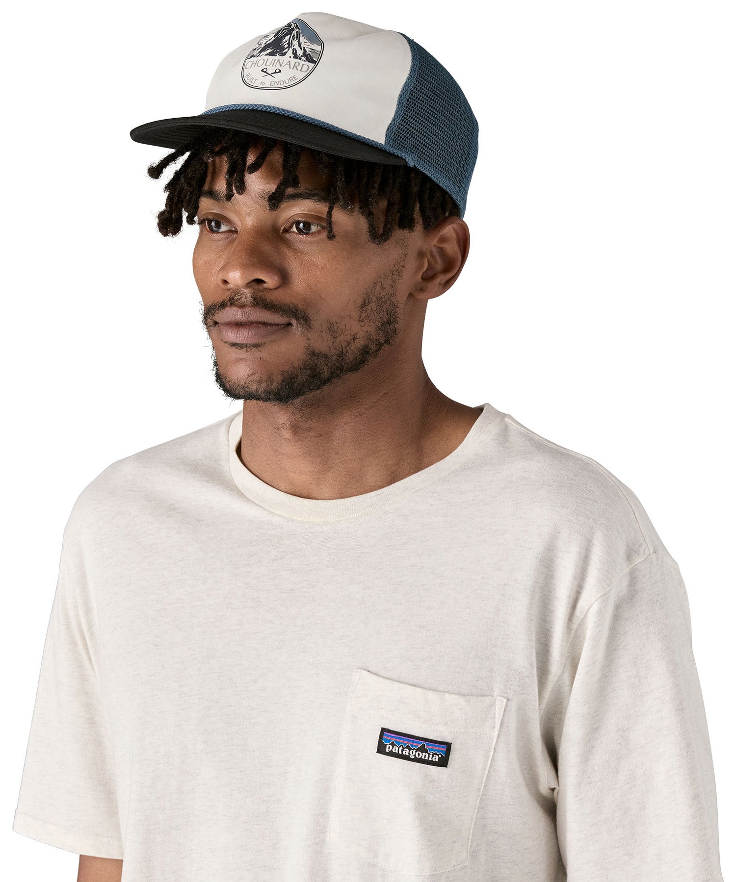 Patagonia airfarer cap in a birch white colour and Chouinard crest design worn by an adult 