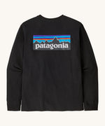 Rear view of the Patagonia Adult  L/S P-6 Logo Responsibili-Tee. A black long sleeve cotton top showing the big brand logo patch printed on the top .