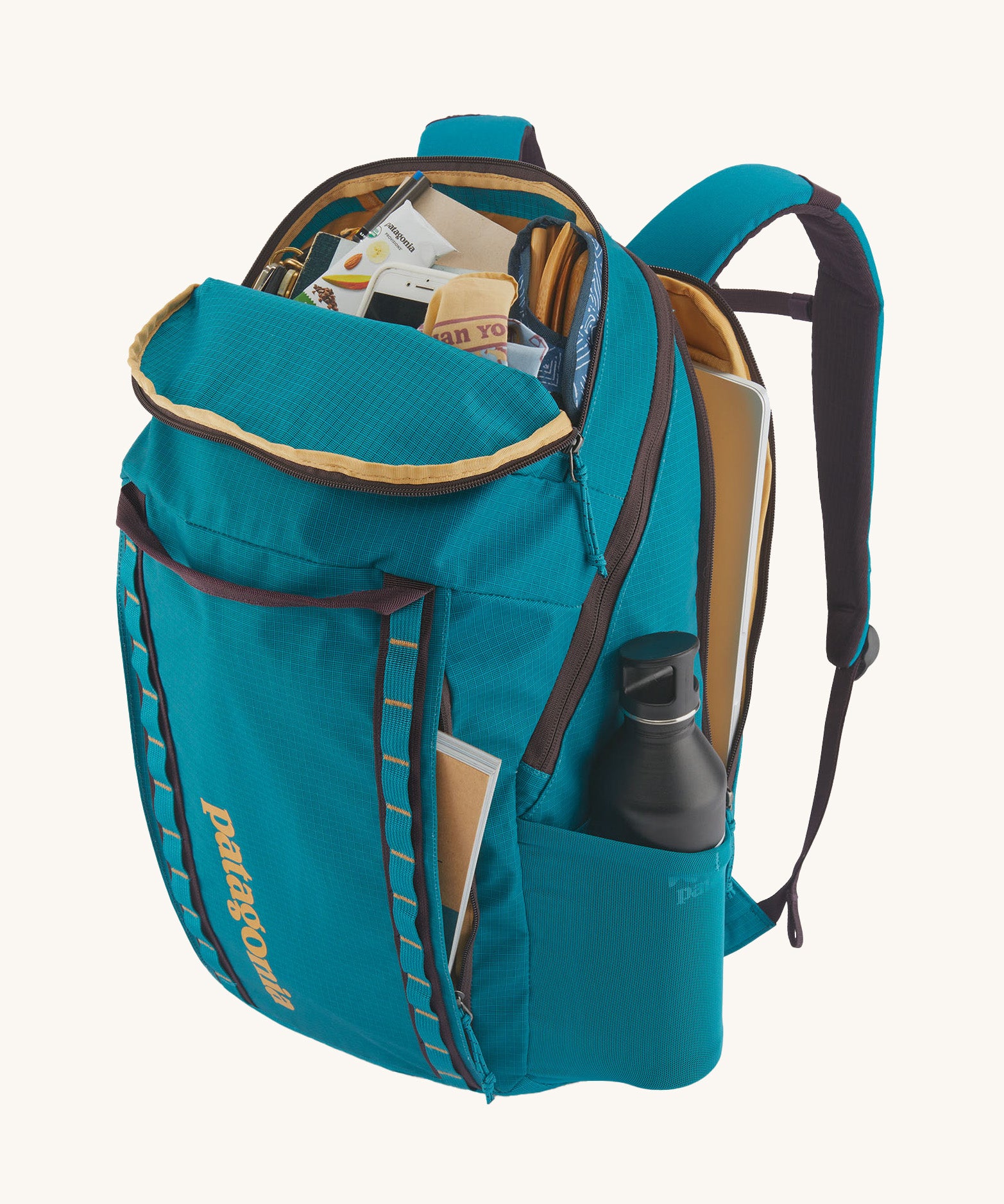 Patagonia 32L black hole backpack  opened with contents inside