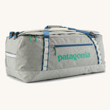 Patagonia black hole 70l duffel bag in birch white with blue zip details and mint green printed logo. 