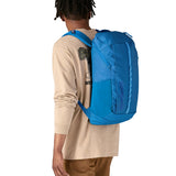 An adult wearing the The Patagonia Black Hole Backpack 25 litre capacity backpack, in endless blue.