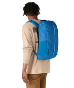 An adult wearing the The Patagonia Black Hole Backpack 25 litre capacity backpack, in endless blue.