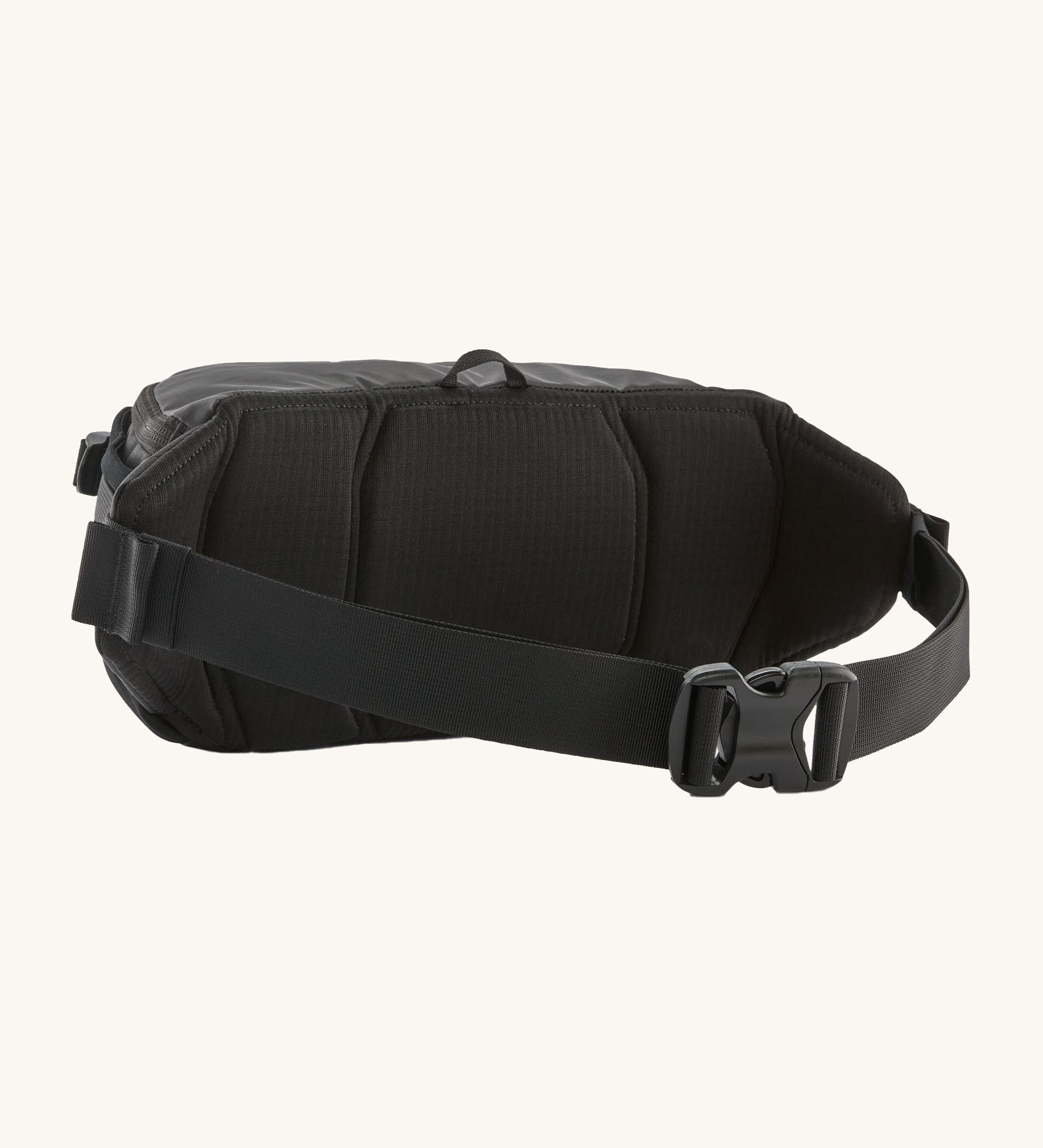 Back of Patagonia black hole waist pack in black showing the buckle fastener detail. 