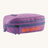 Patagonia 3L black hole cube bag in brisk purple. A 100% recycled bag in vibrant purple with a navy zip detail. Features a bran patch on side and  brand name print  in orange on the top side