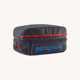 Patagonia Black Hole Cube 6L travel packing cube in Smolder Blue with Amanita Red details, lightweight recycled organiser bag.