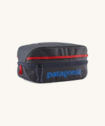 Patagonia Black Hole Cube 6L travel packing cube in Smolder Blue with Amanita Red details, lightweight recycled organiser bag.