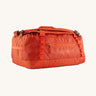 The Patagonia Black Hole Duffel 40L in Pollinator Orange on a plain background.