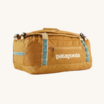 The Patagonia Black Hole Duffel 40L in Pufferfish Gold on a plain background. 