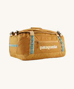 The Patagonia Black Hole Duffel 40L in Pufferfish Gold on a plain background. 