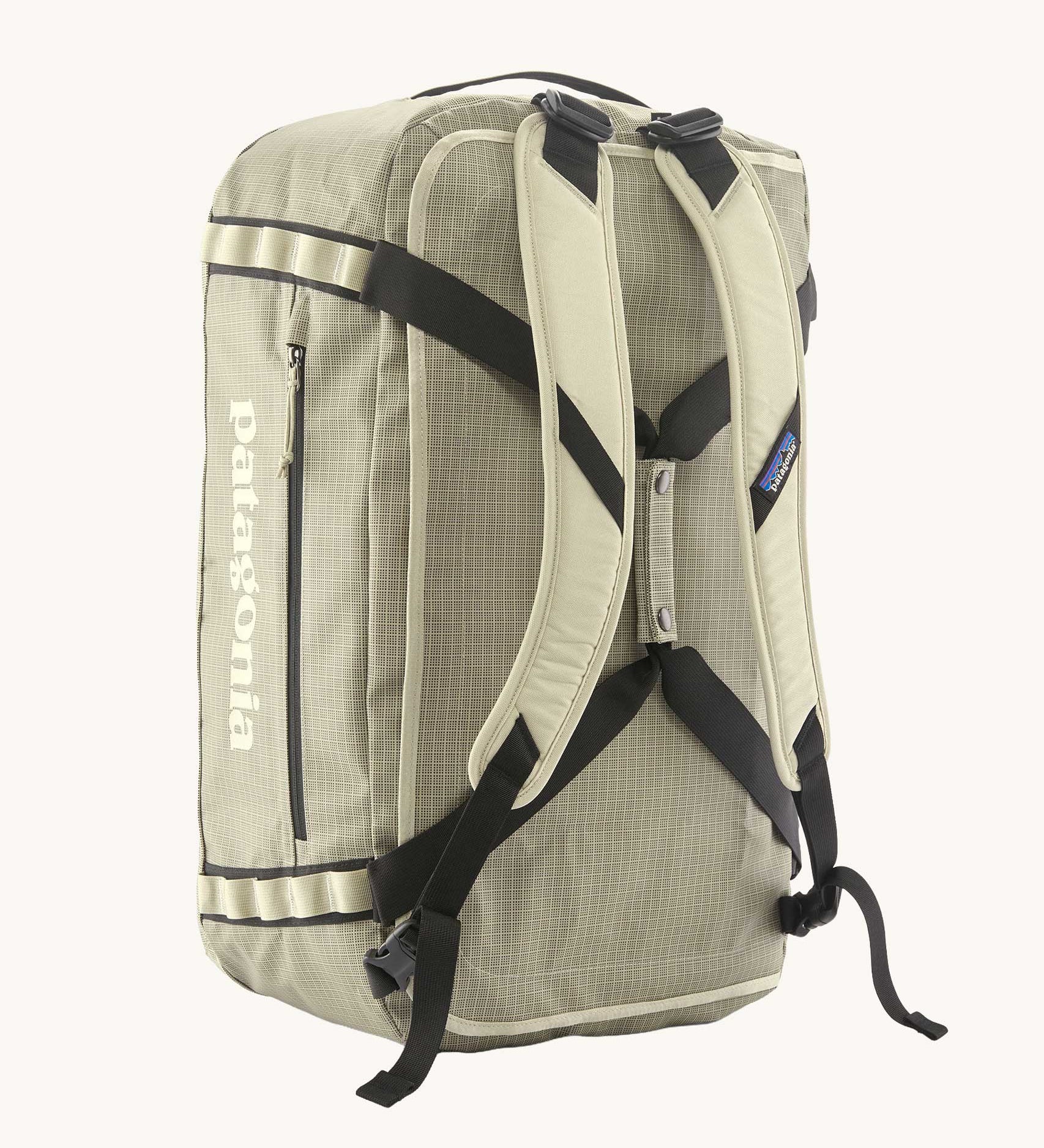 Back of Patagonia black hole duffel 55 litre bag in weathered stone with padded straps.