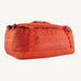 A Patagonia Black Hole Duffel 55L in Pollinator Orange on a plain background.