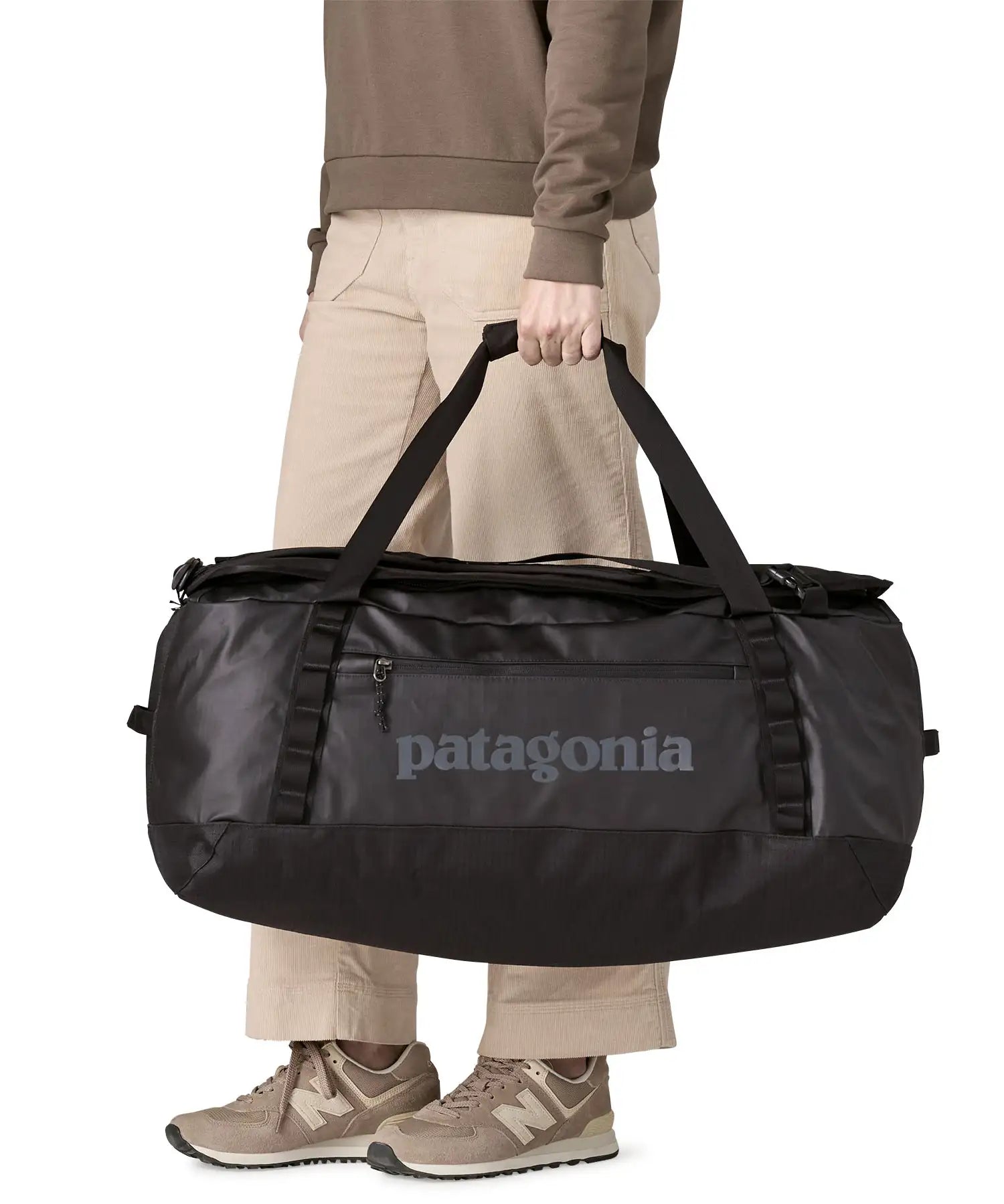 Person holding the Patagonia black Hole duffel bag 70L in black in their hand.