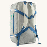 Patagonia black hole 70l duffel bag in birch white with blue straps and padded back straps. 
