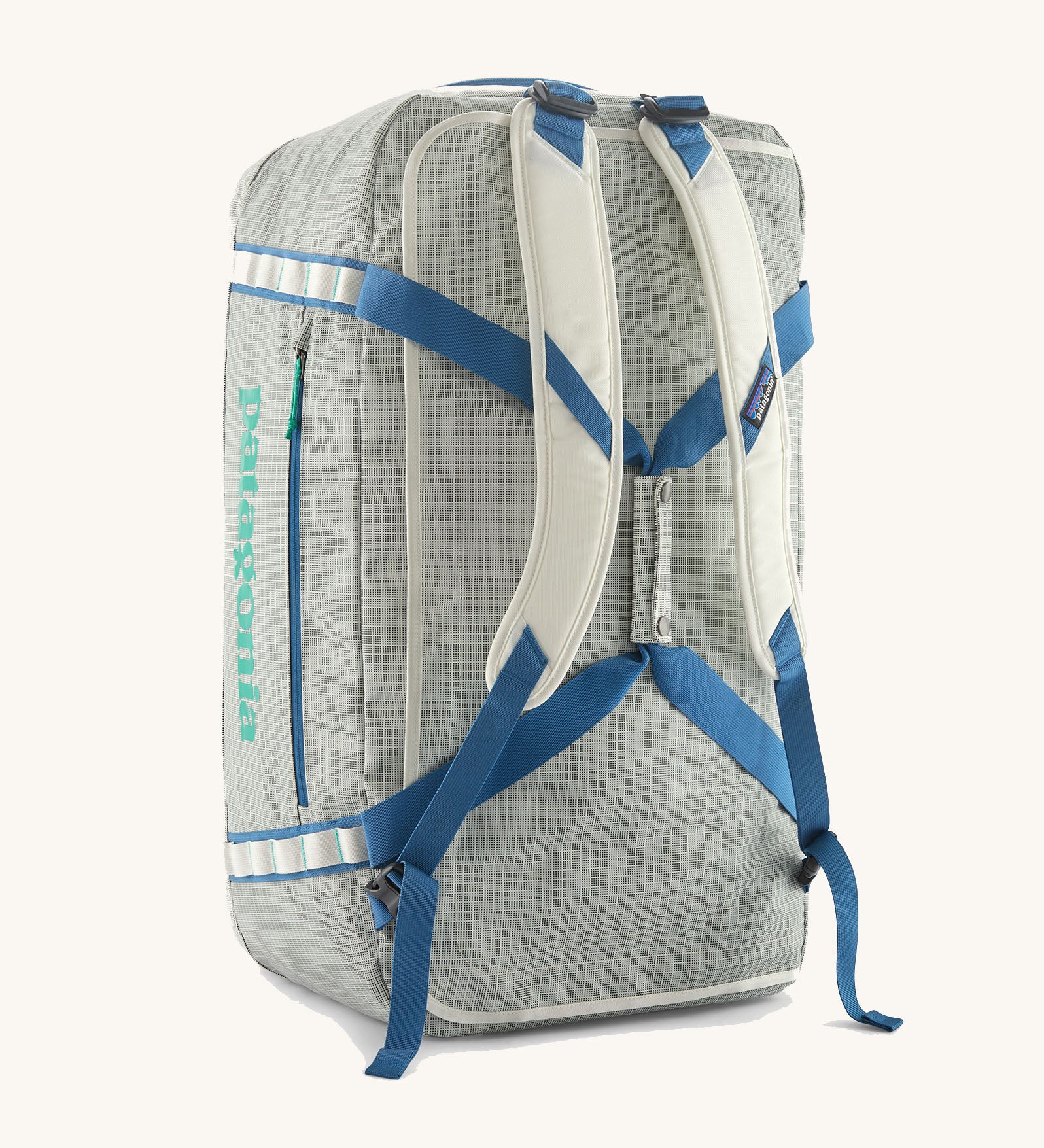 Patagonia black hole 70l duffel bag in birch white with blue straps and padded back straps. 
