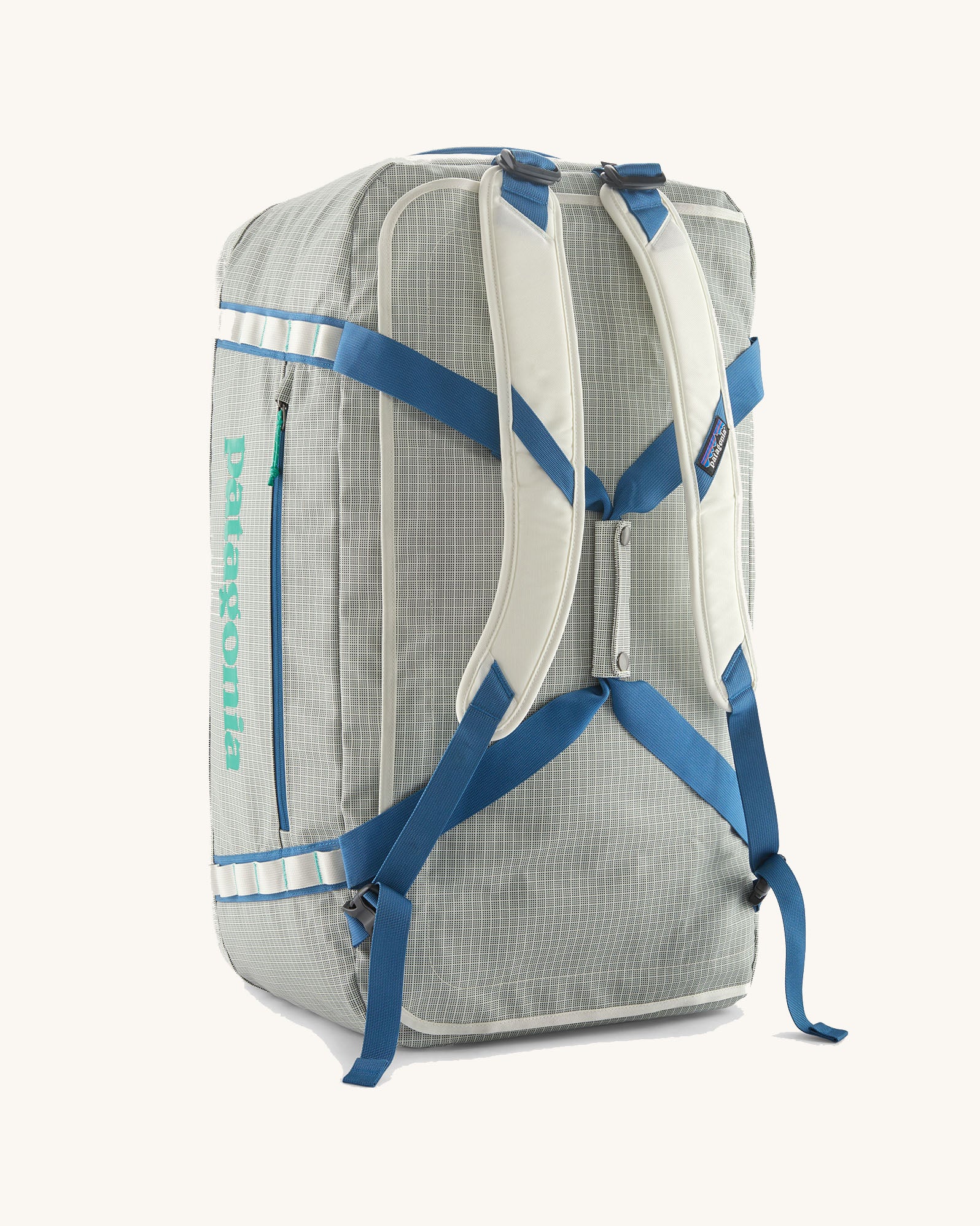 Patagonia black hole 70l duffel bag in birch white with blue straps and padded back straps. 