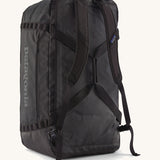 A back view of the large 100 litre capacity Patagonia Black Hole Duffel Luggage Bag, in monochrome all black., showing the shoulder straps. 
